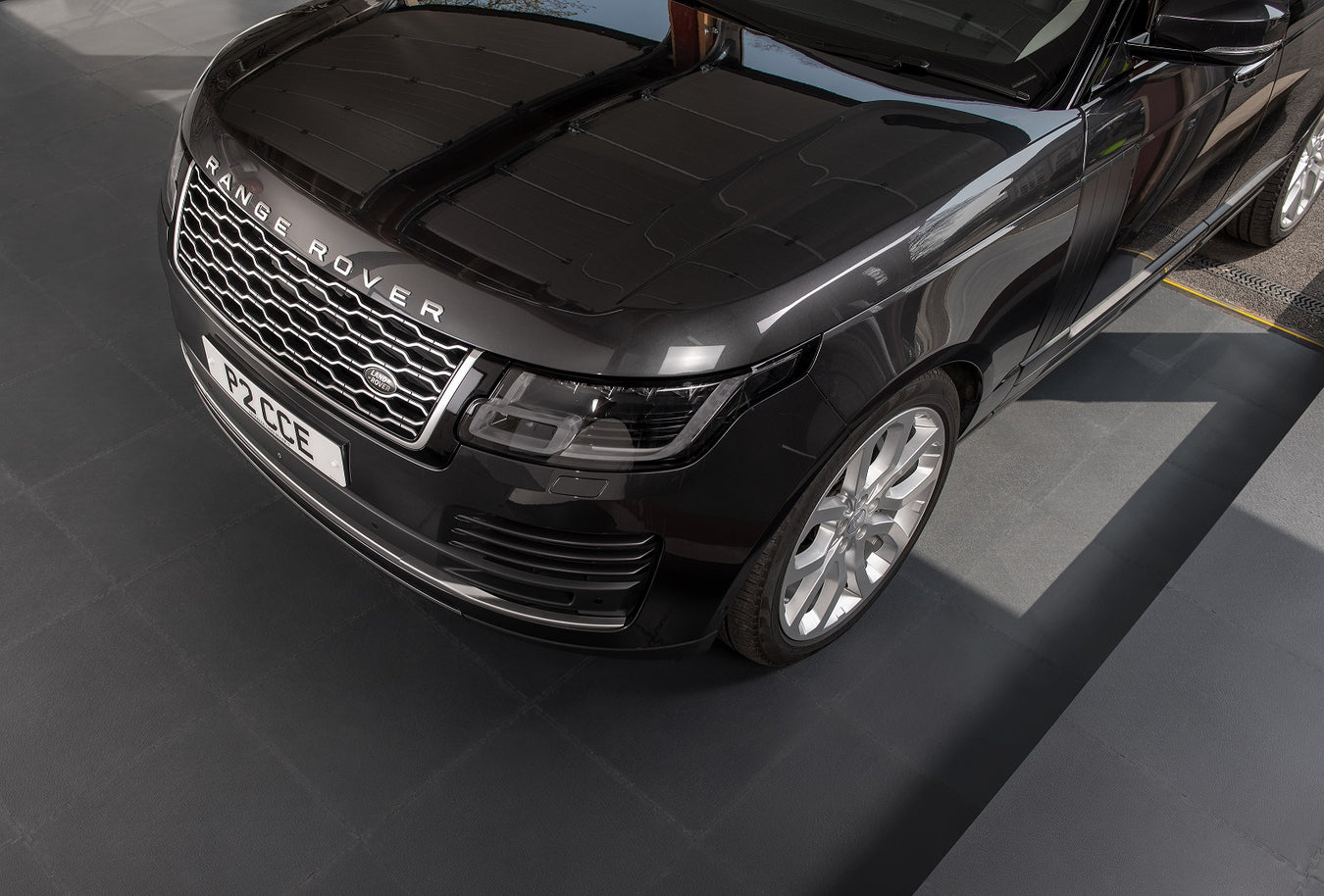 Range rover pulling into garage with reprocessed floor tiles