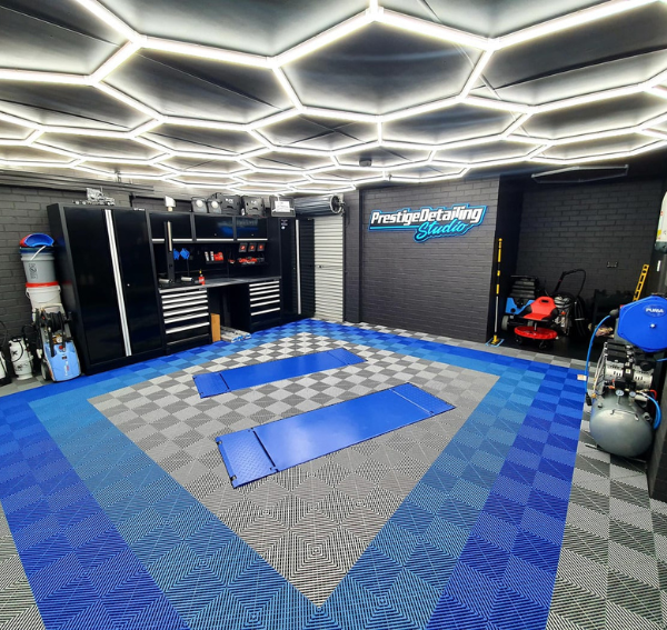 A car detailing garage using Pearl Silver and two different shades of Blue Swisstrax Ribtrax Pro tiles on the floor