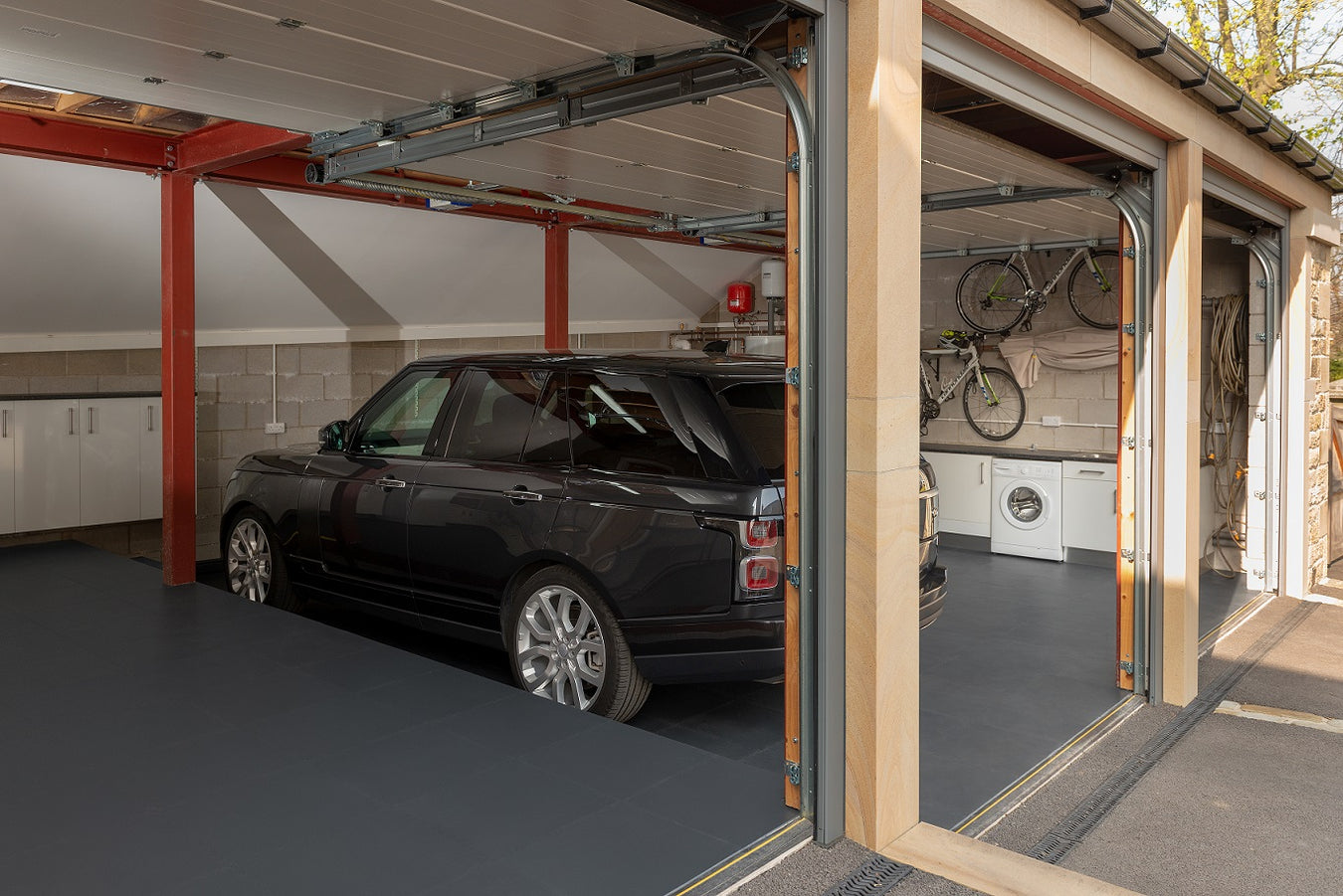 A beautiful garage flooring transformation with a triple bays and range rover