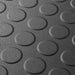 Close up of a Graphite T Joint interlocking Ecotile floor tile with Raised Disc surface finish
