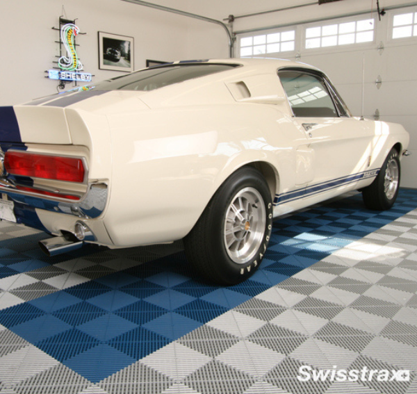 A Pearl Silver and Royal Blue Swisstrax Ribtrax Pro garage floor with a white car on top