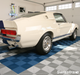 A Pearl Silver and Royal Blue Swisstrax Ribtrax Pro garage floor with a white car on top