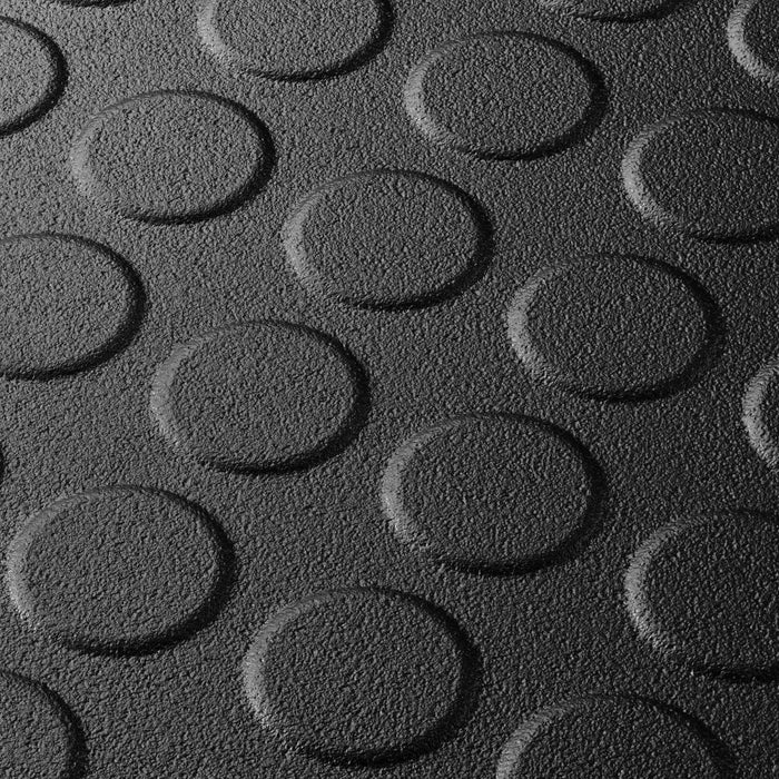 Close up of a Black T Joint interlocking Ecotile floor tile with Raised Disc surface finish