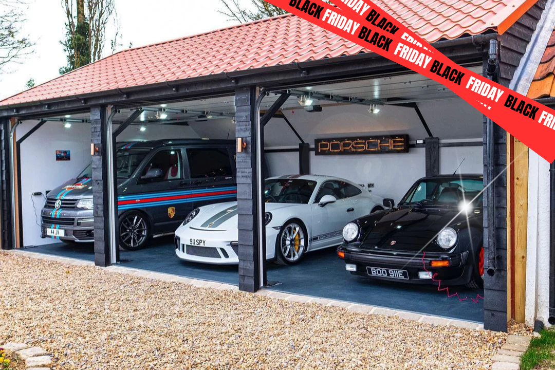 Three luxury cars parked under a garage with special garage flooring and with 'Black Friday' sale signs.