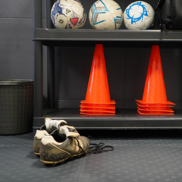 Stacked cones on a shelving unit which sits on top of the Black 5mm Studded Tile